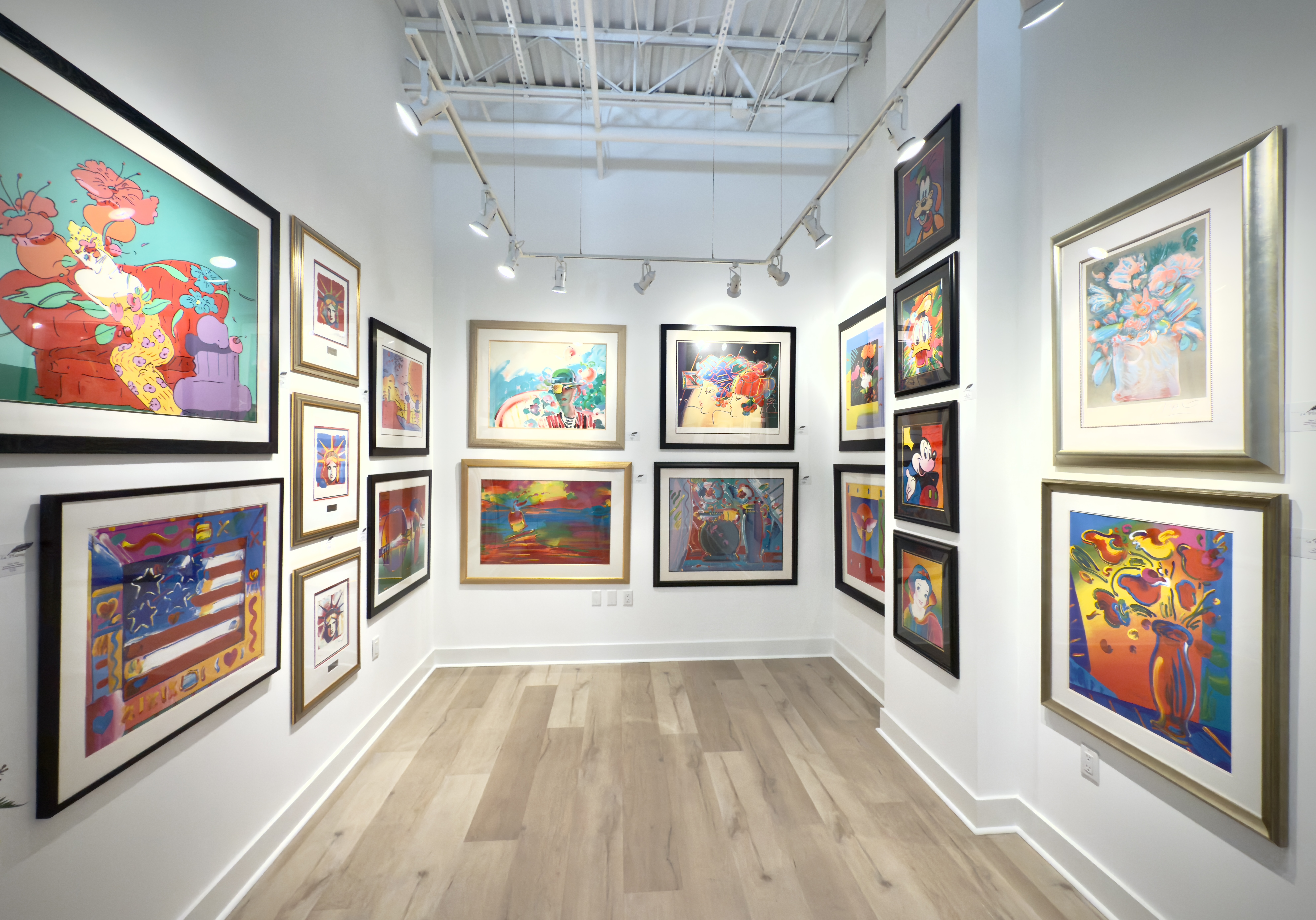 Colorful artwork displayed inside Galerie La Plume